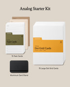 The Analog Starter Kit (Black) features green task cards as part of its innovative paper card system, tan divider cards, white Dot Grid Cards, and a black aluminum card stand displayed on a neutral background.
