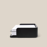A black Analog Capture Kit - Small (Black Aluminum) holds a stack of white, lined index cards against a plain beige background—ideal for organizing your notes.