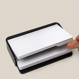 A hand slides a divider card between two stacks of cards in the Analog Capture Kit - Small (Black Aluminum). Text below reads: Included divider card to separate new and used cards.