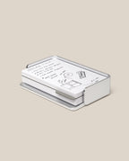 The Analog Capture Kit - Small (Silver Aluminum) features Dot Grid Cards with handwritten notes and sketches neatly arranged in a sleek aluminum tray, creating a stylish workspace accent on a beige background.