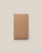 A plain brown box labeled "Analog" (bottom left) and "Someday" (bottom right), shown on a light beige background, features three small circles top right—ideal for storing your Analog - Someday Cards (1-Pack).