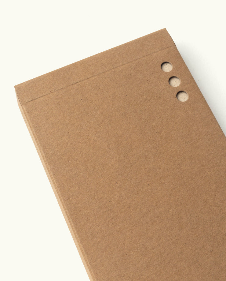 The Analog - Someday Cards (3-Pack) features brown cardboard notebooks with plain uncoated paper cards and three round holes punched along the edge, shown closed on a light background with no writing or decoration.