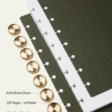 The Discbound Journal (Standard 6" x 8.5") features solid brass discs, thick card stock dark covers, and 120 refillable pages of 70lb white dot grid paper—perfect for note-taking and organization.