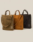Utility Tote Bundle - Set of 3 featuring three durable, heavyweight cotton canvas tote bags in olive green, tan, and dark gray, each with a logo on the bottom corner.