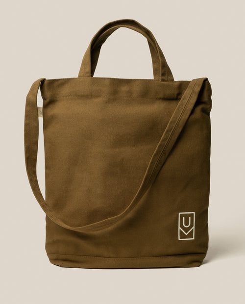 Utility Tote Bundle - Set of 3 olive green heavyweight cotton canvas tote bag with a long shoulder strap and a white geometric logo on the front corner.