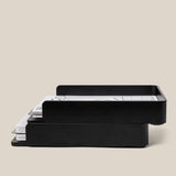 A side view of two Analog Capture Kit - 2 Large (Black Aluminum) trays stacked together holding papers, showcasing their stackable design. Text below: Stackable design lets you combine multiple trays for efficient organization.