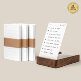 The Analog Daily Focus Kit + 3 Refills (Walnut) features minimalist planner notepads with brown paper bands, a sheet displayed upright in a walnut card holder with a handwritten to-do list, and a #1 Best Seller badge in the top corner.