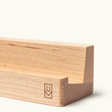 The Analog Weekly Planning Kit (Maple) features a minimalist wooden holder with a groove for cards, a small engraved logo, and a light natural finish. Clean edges and simple design make it ideal for displaying Weekly Planner Cards.