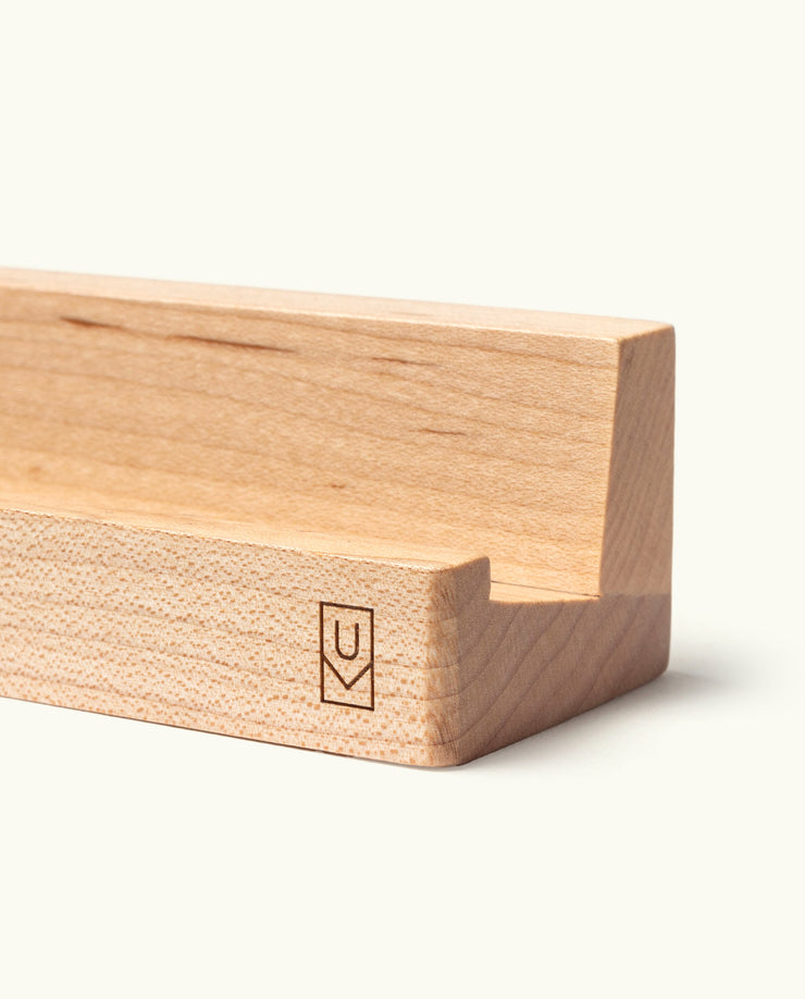 The Analog Weekly Planning Kit (Maple) features a minimalist wooden holder with a groove for cards, a small engraved logo, and a light natural finish. Clean edges and simple design make it ideal for displaying Weekly Planner Cards.