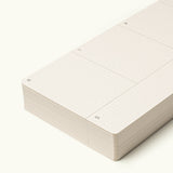 A close-up of a stack of undated Weekly Planner Cards with minimal dotted lines. Columns for M, T, and S are visible on an off-white background—ideal for the Analog Premium Weekly Kit (Maple).
