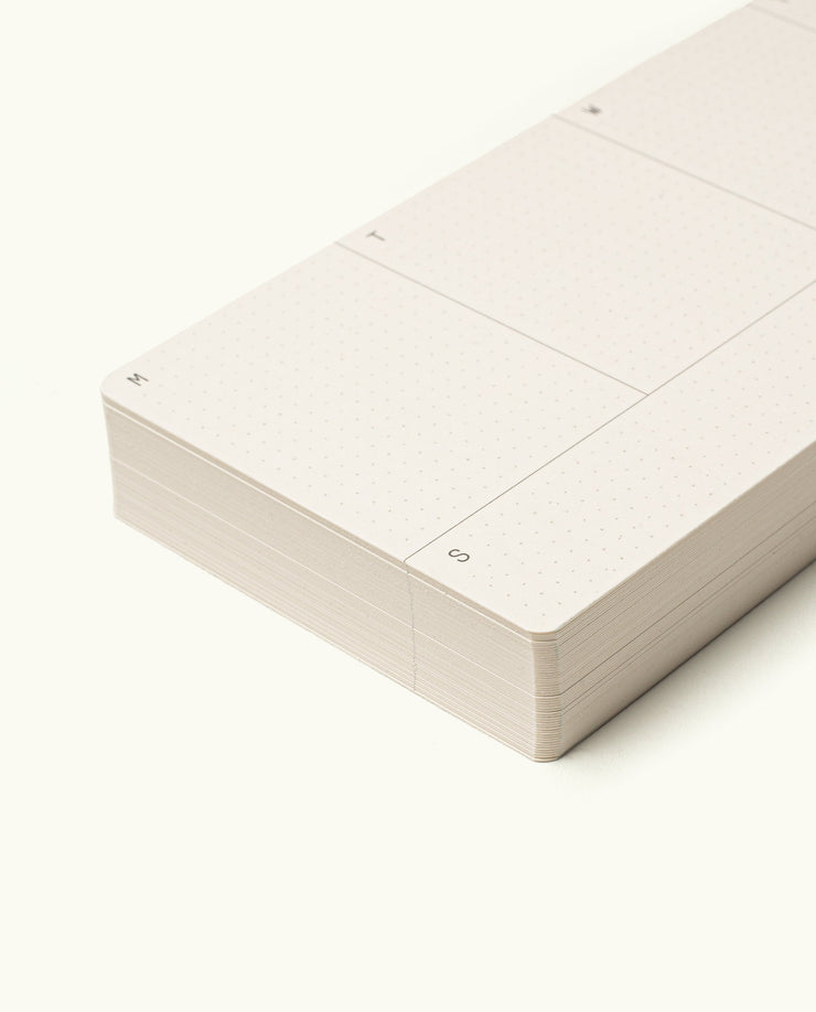 A close-up of a stack of undated Weekly Planner Cards with minimal dotted lines. Columns for M, T, and S are visible on an off-white background—ideal for the Analog Premium Weekly Kit (Maple).