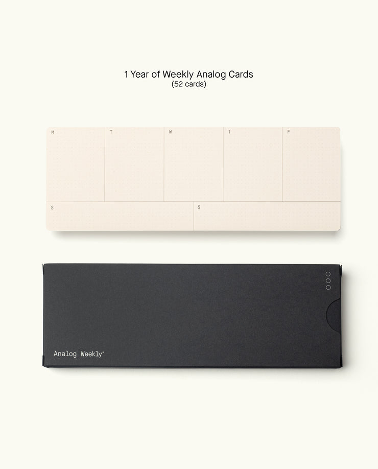 A set of 52 Weekly Cards from the Analog Annual Refill (12 Task Packs + Weekly Cards), featuring beige day-of-week cards atop a black box labeled "Analog Weekly," all displayed on a plain white background.