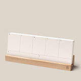 The Analog Weekly Planning Kit (Maple) features white planner cards labeled for each day, neatly arranged in a light maple holder, perfect for minimalist weekly organization.