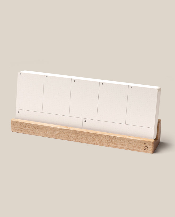 The Analog Weekly Planning Kit (Maple) features white planner cards labeled for each day, neatly arranged in a light maple holder, perfect for minimalist weekly organization.