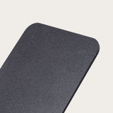 A close-up of the Gather 1x4 Base Plate (Black), a rectangular, matte black steel panel with a textured powder-coated finish and rounded corners, shown against a plain, light background.