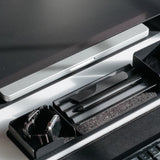 A close-up of a modern desk with a computer monitor, keyboard, and the Gather Zigzag Tray (2x1 - Black) holding two pens, plus another tray with a smartwatch—all neatly arranged on a black and white desk.