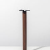 The Gather Headphone Stand (1x1 - Black/Walnut) features a vertical walnut wood column, a square black powder-coated steel base, and a black metal platform, shown against a plain white background.