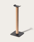 Introducing the Gather Headphone Stand (1x1 - Black/Maple), featuring a solid maple wood vertical post, a sleek black powder coated steel base, and a curved black top designed to elegantly display your headphones.