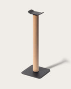 Introducing the Gather Headphone Stand (1x1 - Black/Maple), featuring a solid maple wood vertical post, a sleek black powder coated steel base, and a curved black top designed to elegantly display your headphones.