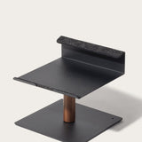 The Gather Laptop Stand (Black/Walnut) is a modern, minimalist ergonomic stand with a flat base, vertical walnut support, and raised platform with felt-lined edge for secure device holding—expertly made in the USA.
