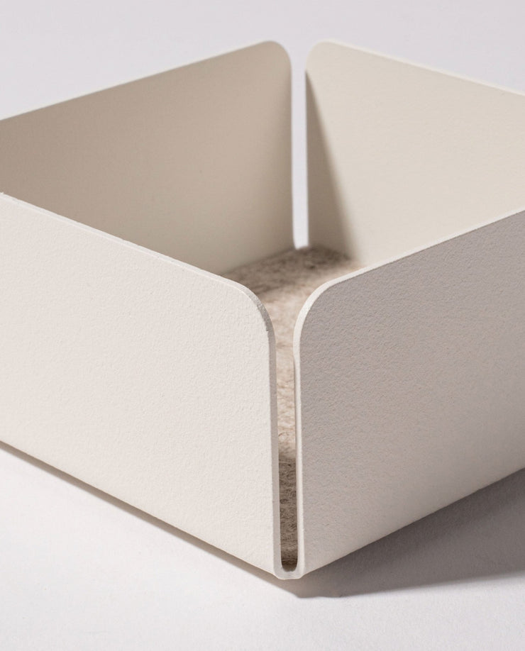 The Gather Small Tray (1x1 - White) is a minimalist, white square tray with rounded corners and a felt-lined base, ideal as a desk organizer. Made in Pennsylvania, it sits perfectly on any light surface.