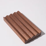 The Gather Wood Zigzag Tray (2x1 - Walnut) is crafted from solid walnut and features a unique zigzag design, making it a stylish holder for pens and pencils.