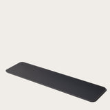 The Gather 1x4 Base Plate (Black) is a slim, rectangular wrist rest with rounded corners and a powder-coated steel base, designed for keyboard use and shown against a plain white background.