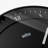 Close-up of the Braun Wall Clock (Black), featuring an easy-to-read minimalist design with white hands and bold numbers 11, 12, and 1.