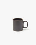 The Hasami Porcelain Mug (Matte Black) features a plain, modern design with a large handle and slightly rounded rim, shown here on a white background.
