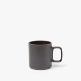 The Hasami Porcelain Mug (Matte Black) features a plain, modern design with a large handle and slightly rounded rim, shown here on a white background.