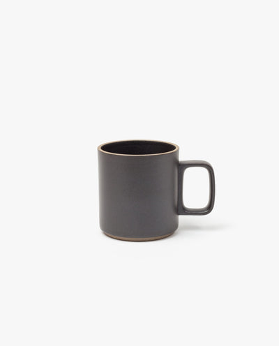 The Hasami Porcelain Mug (Matte Black) features a plain, modern design with a large handle and slightly rounded rim, shown here on a white background.