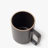The Hasami Porcelain Mug (Matte Black) features a square handle and is shown from above and slightly to the side on a plain white background, highlighting its visible rim and interior.