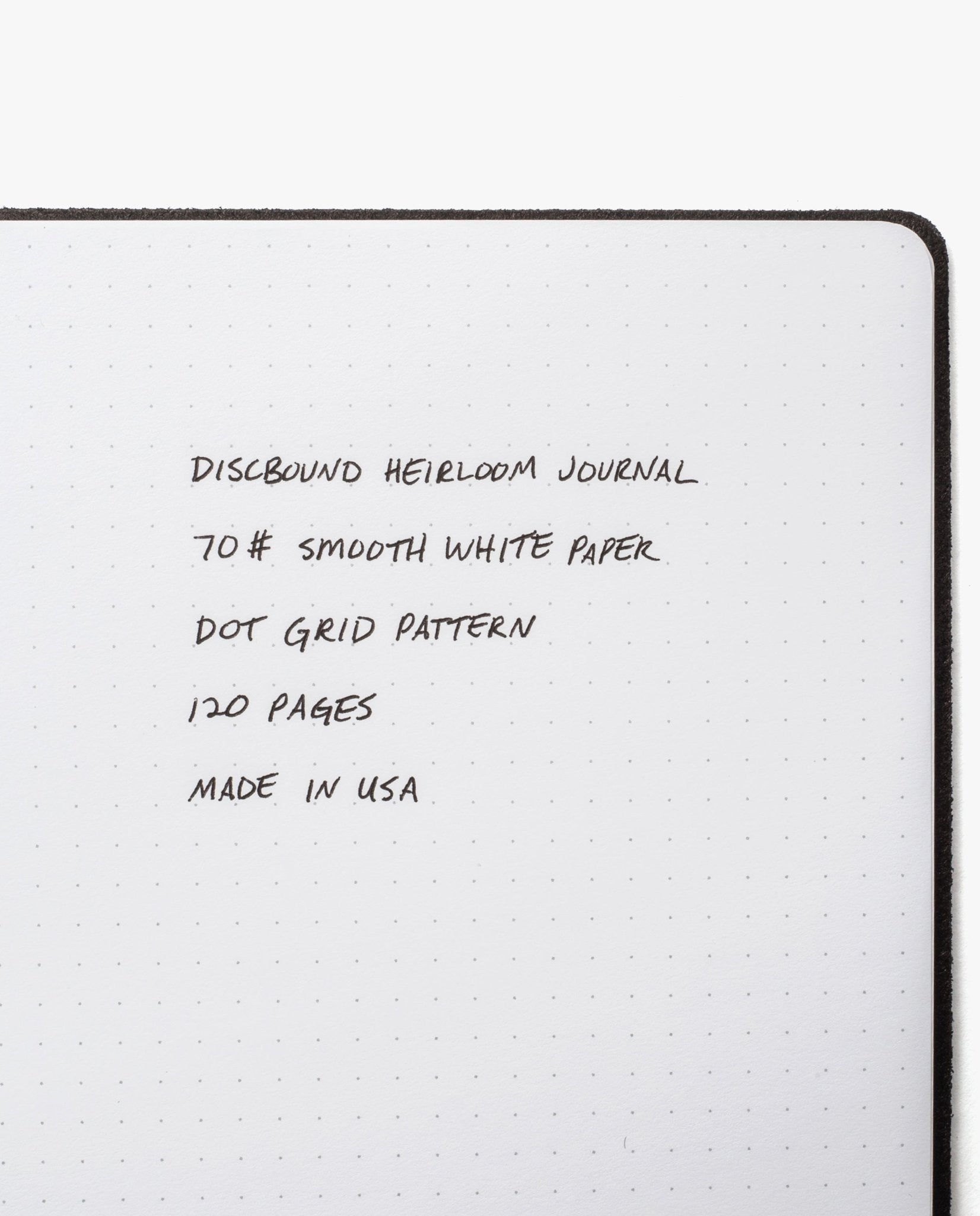 An open Discbound Heirloom Journal Bundle (Black Leather - Standard 6" x 8.5" + 3 Refills) with dotted grid pages, refillable design, 70# smooth white paper, 120 pages per refill, made in the USA.