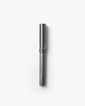 A LAMY Lx Rollerball (Ruthenium) with a capped lid is positioned vertically against a plain white background, ready to provide smooth writing with its refillable rollerball design.