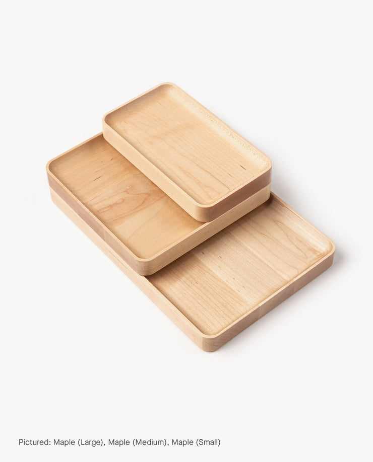 The Valet Tray (Maple - Medium) features smooth, rounded edges and a light natural solid maple wood finish, shown stacked with other sizes on a white background.