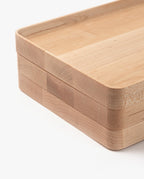 A close-up of two stacked Valet Tray (Maple - Large), handcrafted from solid maple with rounded corners and smooth edges, set against a white background.