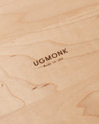 Close-up of light wood surface with "UGMONK Made in USA" engraved in the center, highlighting the wood grain and engraving on this handcrafted Valet Tray (Maple - Large).