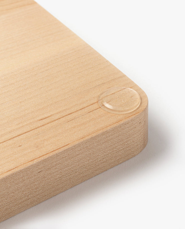 A close-up of the Valet Tray Bundle (Maple - Set of 3) handcrafted in Pennsylvania shows smooth, rounded corners and a single water droplet that highlights the maple wood’s natural texture and refined finish.