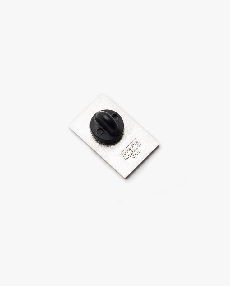 A Ugmonk Enamel Pin with a rectangular shape and black rubber clutch backing is centered on a plain white background.