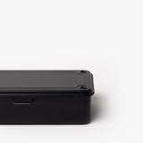 Partially shown against a plain white background, the Toyo Steel Stackable Storage Box T-190 (Black) features a black rectangular metal design with rounded edges and visible screws on the lid, highlighting its classic stackable toolbox style.