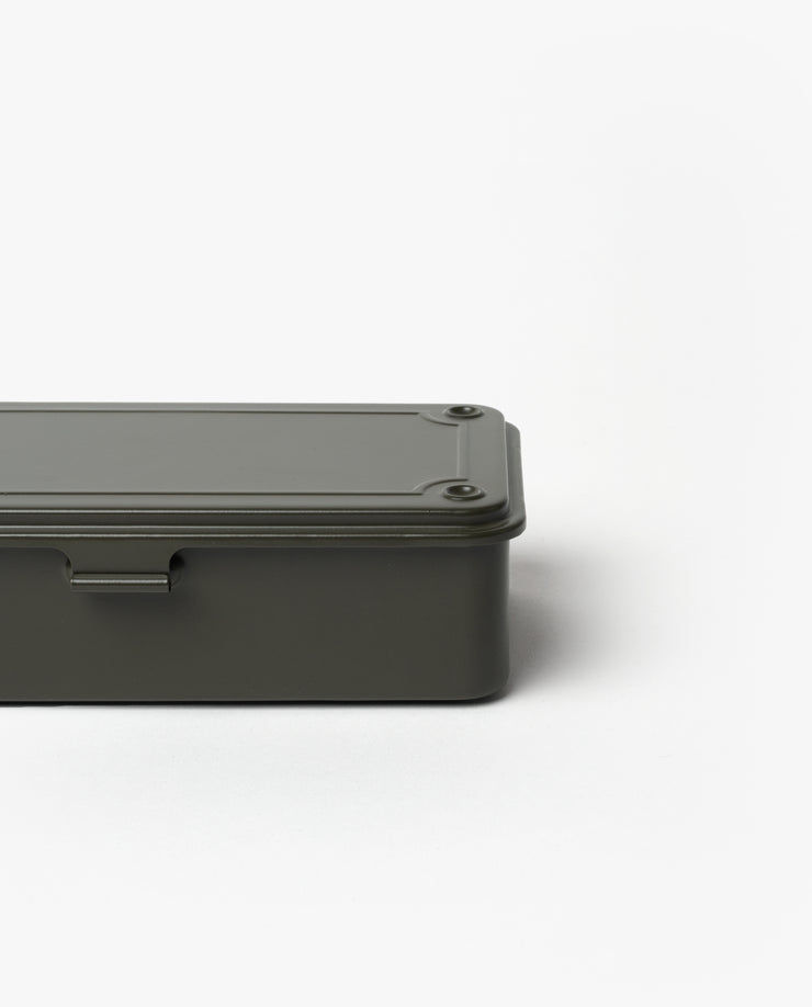 The Toyo Steel Stackable Storage Box T-190 in Military Green is a minimalist Japanese-made steel box with rounded edges, a flat screw-fastened lid, and stackable design, shown partially set against a plain white background.