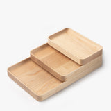 The Valet Tray Bundle (Maple - Set of 3) features handcrafted rectangular trays of different sizes with rounded corners and smooth edges, made in Pennsylvania and stacked together on a white background.
