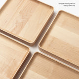 Four medium maple Valet Trays with rounded edges are arranged diagonally on a white surface, displaying unique wood grain patterns. Text in the corner reads, Unique wood grain on every handcrafted Valet Tray (Maple - Medium).