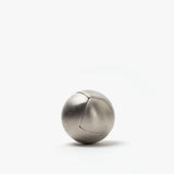 The Craighill Venn Puzzle (Stainless Steel) is a smooth, metallic sphere with a subtle curved seam, elegantly resting on a plain white background.