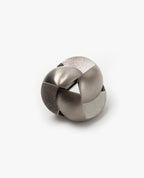 The Craighill Venn Puzzle (Stainless Steel) is a metallic, interlocking mechanical puzzle featuring smooth and brushed silver surfaces with a complex, rounded shape set against a plain white background.