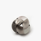 The Craighill Venn Puzzle (Stainless Steel) is a metallic, interlocking mechanical puzzle featuring smooth and brushed silver surfaces with a complex, rounded shape set against a plain white background.