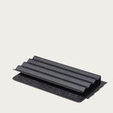 The Gather Zigzag Tray (2x1 - Black) is a black, rectangular tray with ridged, layered design, made from powder-coated steel, shown on a light neutral background and ideal as a modern desk organizer.